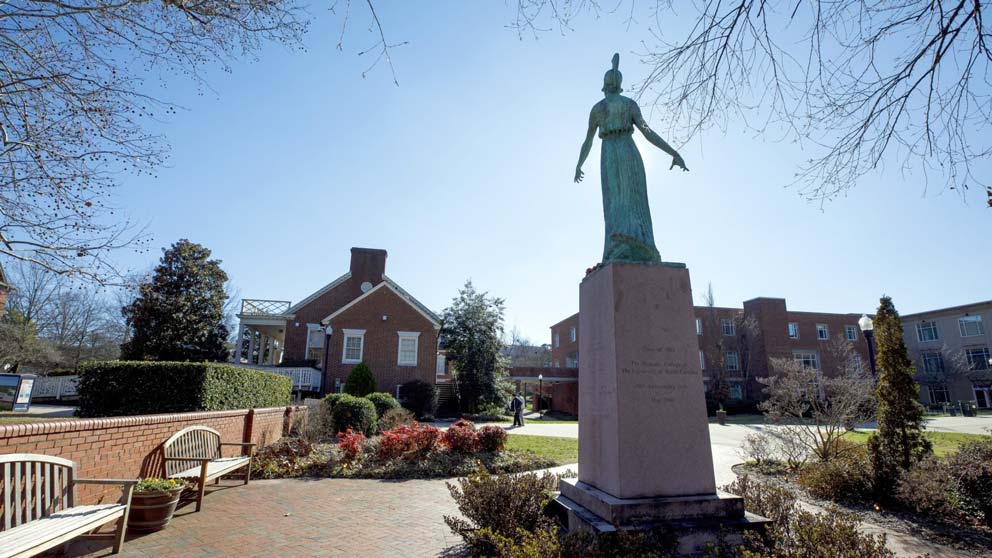 Backlit shot of Minerva statue on UNCG campus.